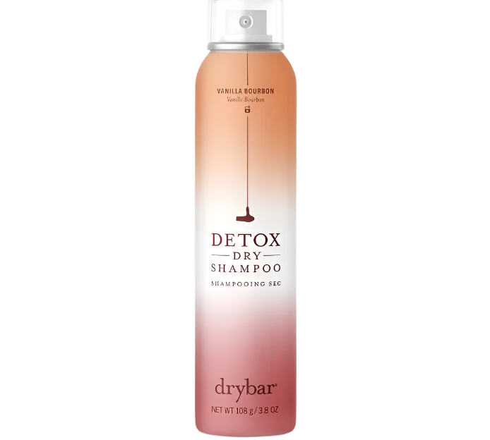 A full-size cylindrical can of Drybar Detox Dry Shampoo is designed with a smooth gradient from beige to deep red, featuring a "Vanilla Bourbon" label. This 3.8 FL.OZ formula effectively absorbs excess oil, leaving hair feeling refreshed and revitalized.