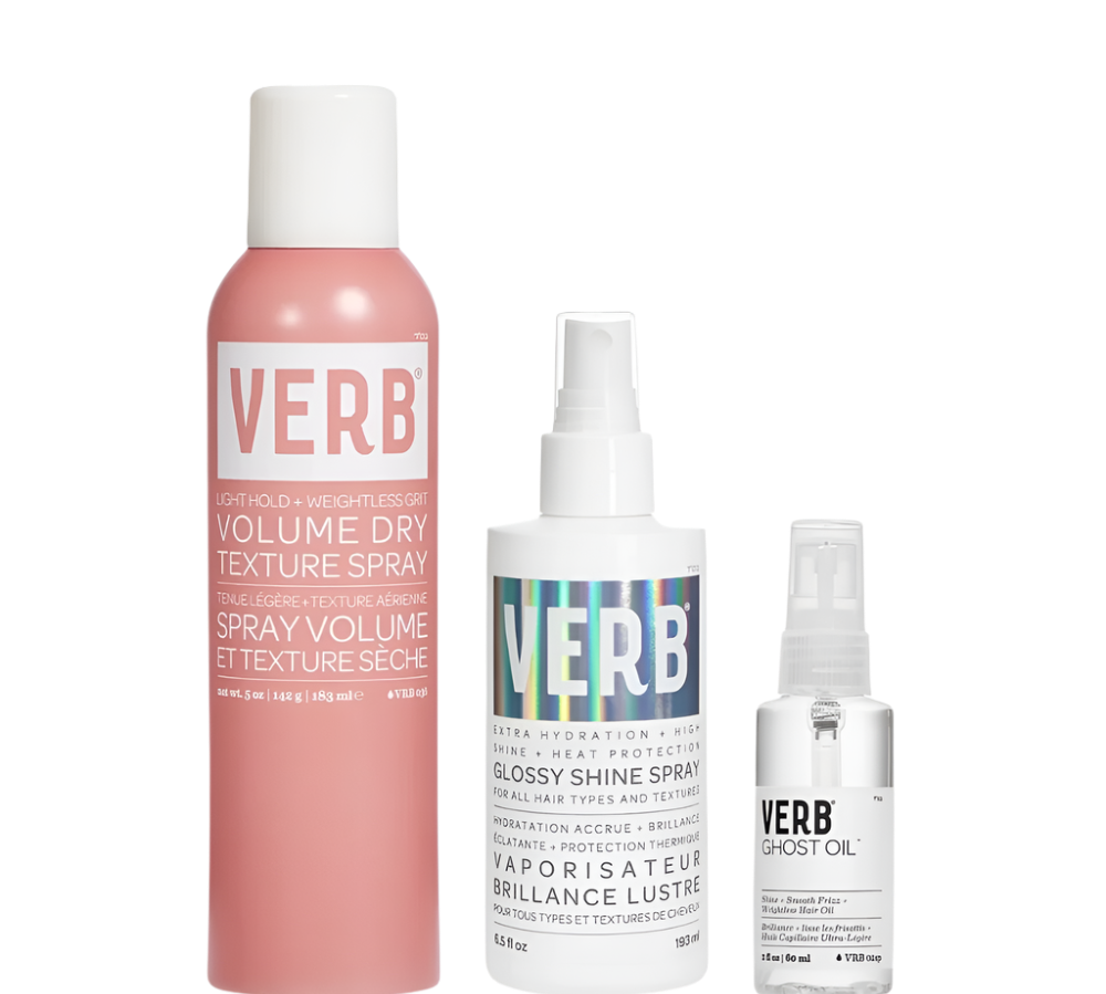 A trio of Verb hair products, known as the Verb 3-Pc. Trio coiffant gagnant, featuring a pink bottle of Volume Dry Texture Spray, a white bottle of Glossy Shine Spray, and a small clear bottle of Ghost Oil, are arranged side by side against a white background.