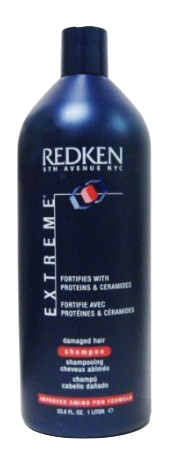 A bottle of Redken Extreme Shampoo for damaged hair. This protein-enriched shampoo is packaged in a blue 33.8 fl. oz (1 liter) bottle, labeled "Fortifies with Proteins & Ceramides," and is perfect for restoring strength and vitality to your hair.