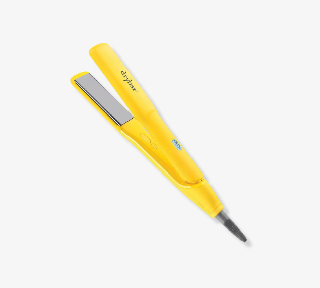 The Drybar Tress Press Straightening Iron, featuring a vibrant yellow color set against a white background, showcases titanium plates and adjustable temperature settings for achieving sleek hair. The brand logo is prominently displayed on the handle.