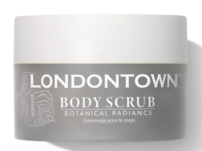 The LONDONTOWN Botanical Radiance Body Scrub, a vegan and cruelty-free exfoliator, comes in a 7.7 oz gray jar adorned with a subtle leaf design on the left side. The label features crisp white text that emphasizes its enriching blend of nourishing botanicals and is topped with a light gray lid, promising a radiant skincare experience.