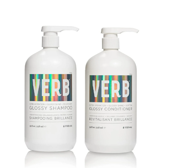 Two 32 fl oz (946 ml) bottles of the verVerb Glossy Shampoo & Conditioner Set, each with a pump dispenser and featuring sulfate-free, color-safe labels with a holographic design that highlights extra hydration and glossiness for hair.