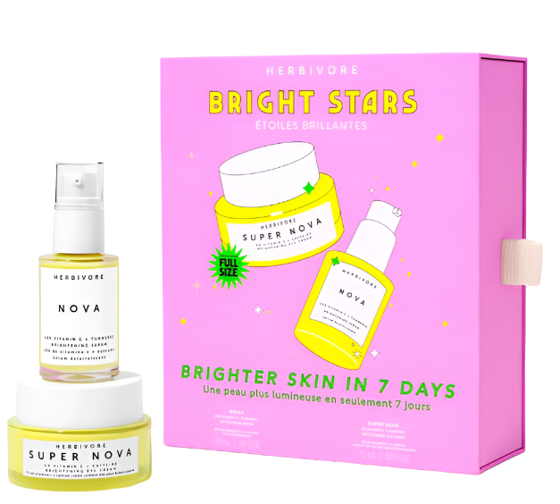 A pink box labeled HERBIVORE Bright Stars Brightening Set, featuring illustrations of skincare bottles, promises Brighter Skin in 7 Days. In front, two products—Nova and Super Nova—focus on reducing dark spots for a more even skin tone.