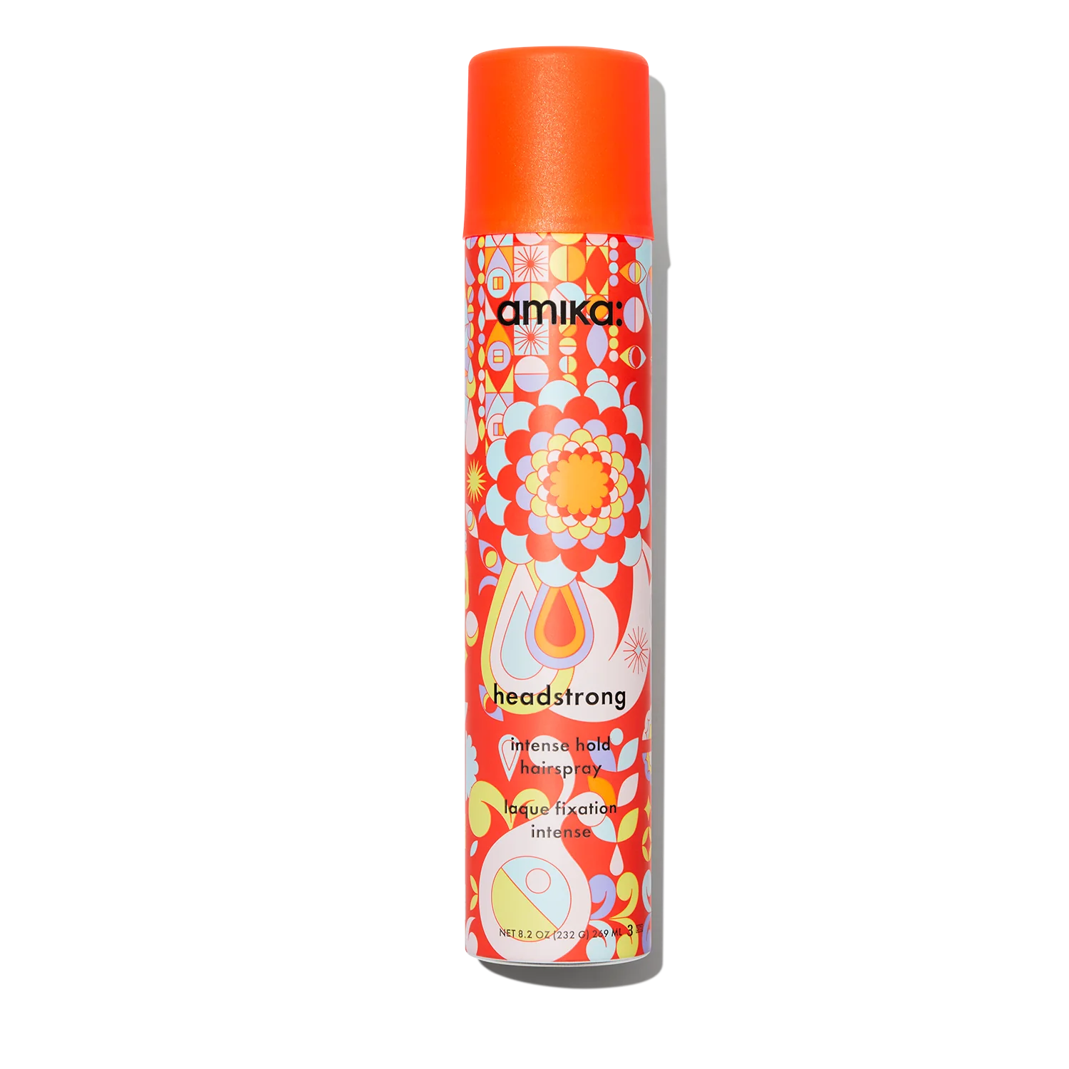 A vibrant spray can features a retro design with floral and abstract patterns, topped with an eye-catching orange cap. The label reads "Amika headstrong intense hold hairspray 8.2 Fl.oz," promising a humidity-resistant formula for flawless styling in any weather.