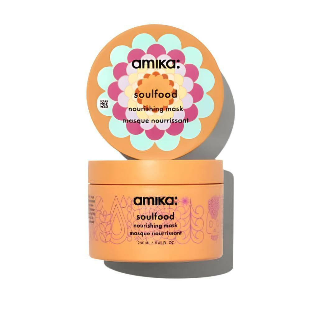 The Amika soulfood nourishing Mask, 8 Fl oz, container is displayed with its lid open, showcasing a vibrant floral design. The orange packaging prominently highlights its deep-conditioning capabilities and assures repair for all hair types in sleek black text.