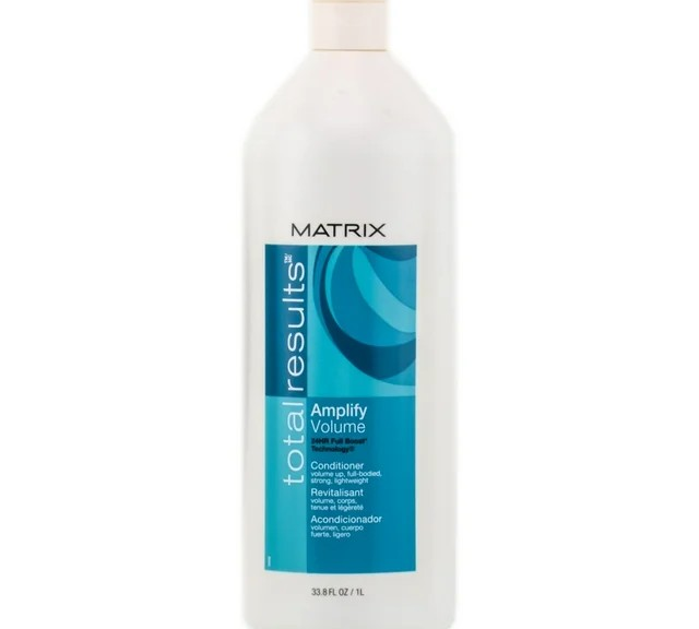 The Matrix Total Results Amplify Conditioner, 33.8 oz, comes in a white cylindrical bottle with a tapered top and a white cap. Its blue and white label design highlights its protein enrichment for added fullness, making it ideal for boosting volume.