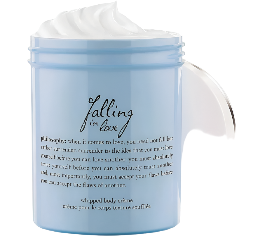 A light blue jar of Philosophy Whipped Body Creme titled "Falling in Love" features a philosophical message about self-love and acceptance. The open jar reveals a swirl of whipped cream that emits a romantic, sweet scent and ensures long-lasting moisture.